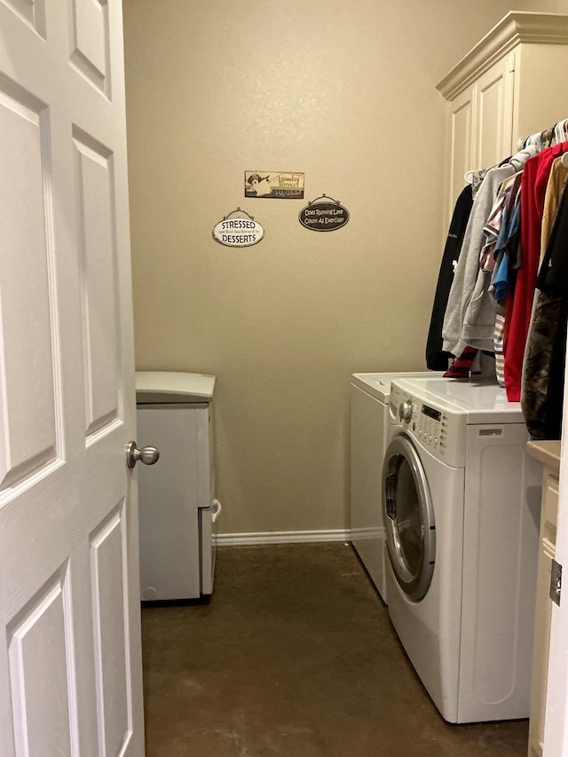 washroom featuring cabinets and independent washer and dryer