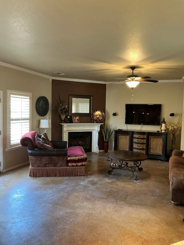 living room with ceiling fan, a textured ceiling, and ornamental molding