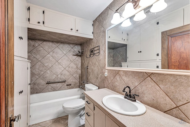 full bathroom featuring tile walls, decorative backsplash, tiled shower / bath combo, vanity, and toilet