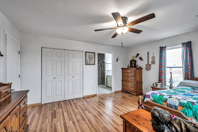 bedroom with ceiling fan, connected bathroom, light wood-type flooring, and a closet