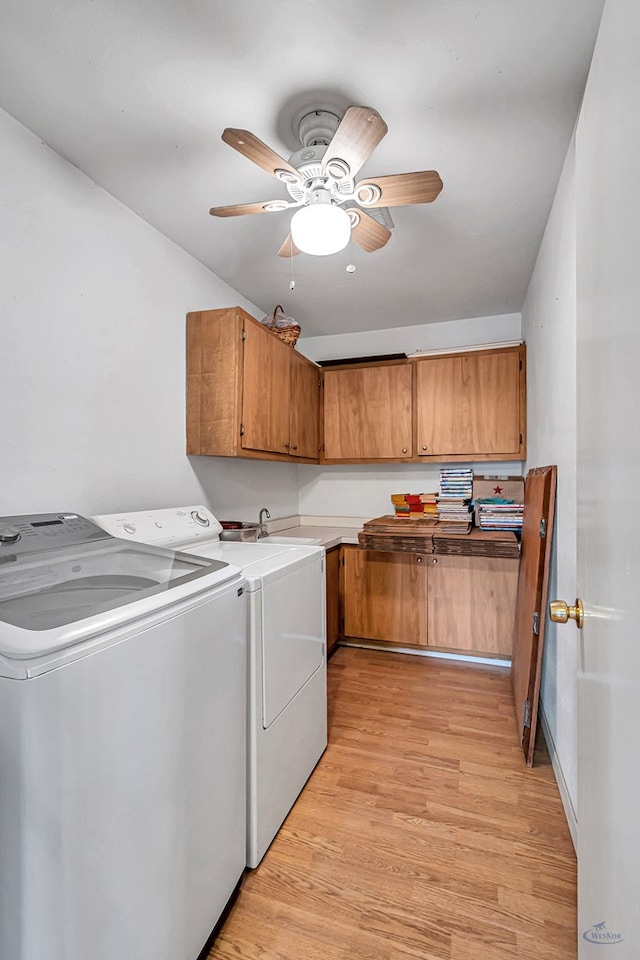 laundry area featuring separate washer and dryer, cabinets, ceiling fan, and light wood-type flooring