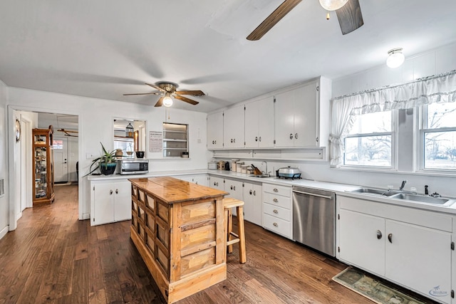 kitchen featuring dark hardwood / wood-style floors, sink, white cabinets, ceiling fan, and stainless steel appliances