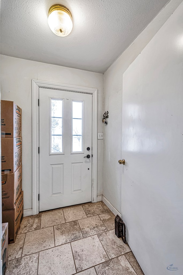 entryway with a textured ceiling