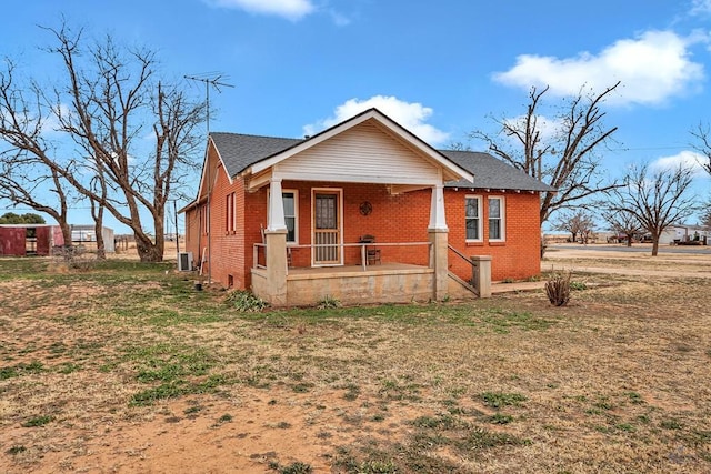 bungalow-style house featuring a porch and central AC unit