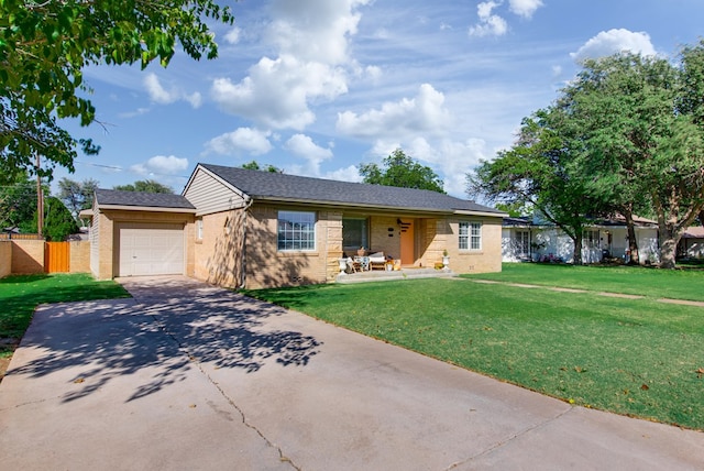 single story home with a front yard, a porch, and a garage