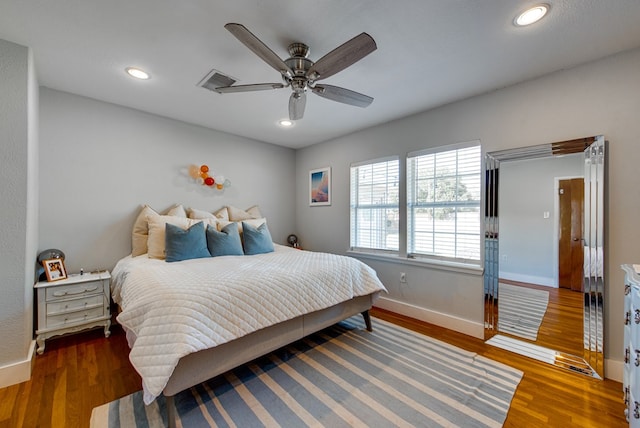 bedroom featuring ceiling fan and dark hardwood / wood-style flooring