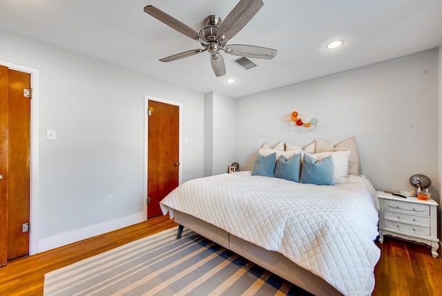 bedroom with ceiling fan and dark wood-type flooring