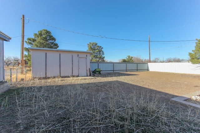 view of yard featuring a fenced backyard and an outdoor structure