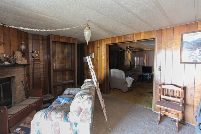 interior space featuring carpet floors, a brick fireplace, and wooden walls