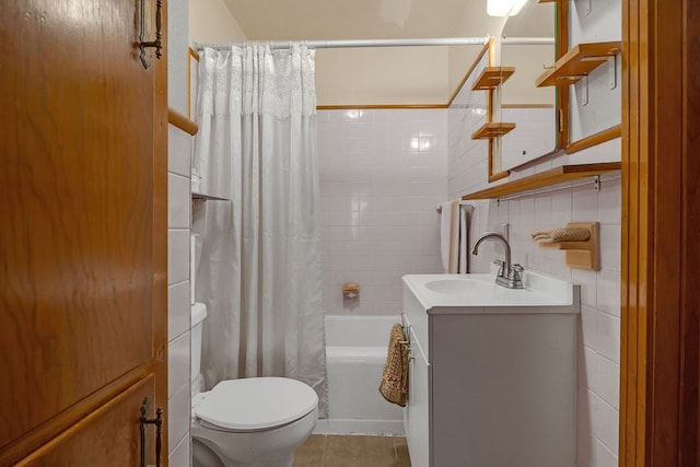 bathroom with shower / bath combination with curtain, tile walls, tile patterned flooring, vanity, and toilet