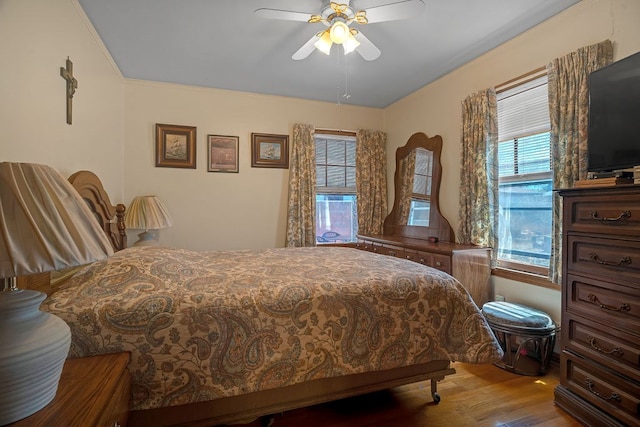 bedroom with a ceiling fan and wood finished floors