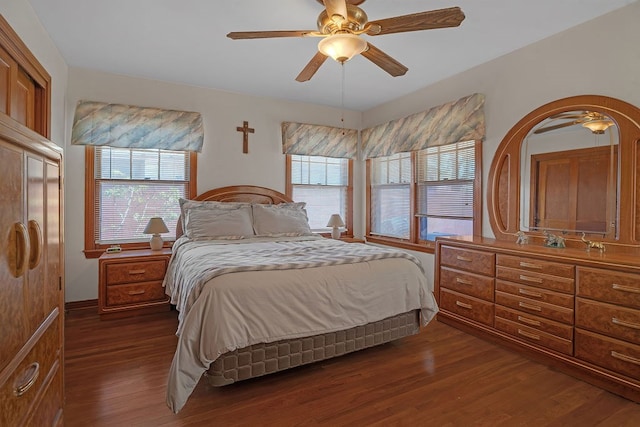 bedroom with dark wood-style flooring, ceiling fan, and multiple windows