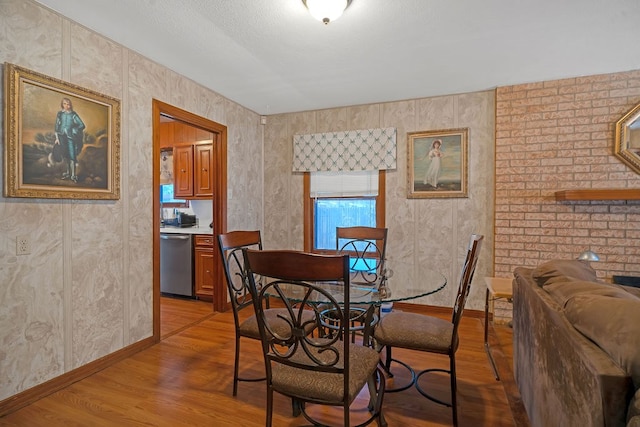 dining area featuring light wood-style floors and baseboards