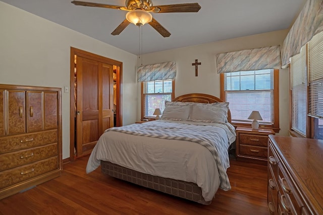 bedroom featuring a ceiling fan and dark wood-type flooring