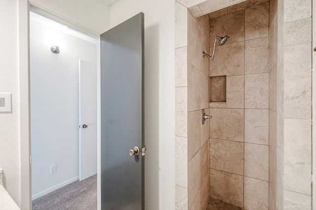 bathroom with a tile shower