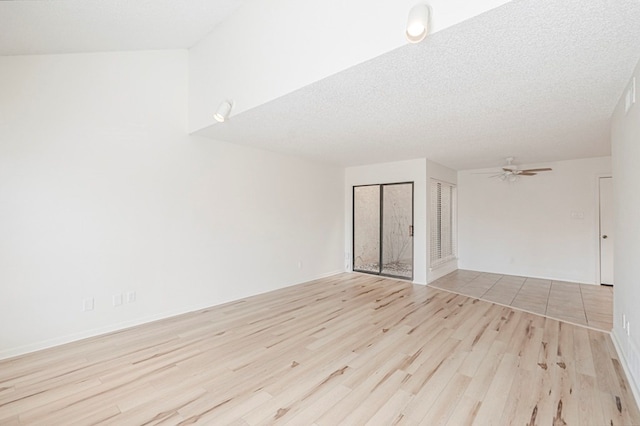 unfurnished room featuring light wood-type flooring, a textured ceiling, and a ceiling fan