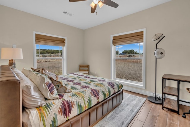 131 High Lonesome Dr, Alpine, TX 79830 - bedroom featuring multiple windows, light wood finished floors, baseboards, and a ceiling fan