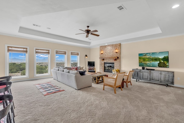 131 High Lonesome Dr, Alpine, TX 79830 - living room with a raised ceiling, light colored carpet, a fireplace, plenty of natural light, and recessed lighting