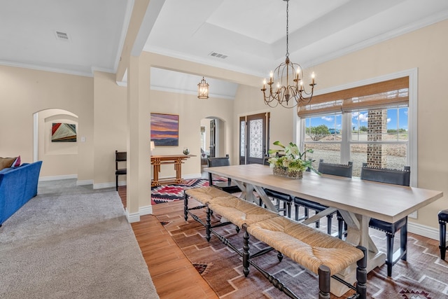 131 High Lonesome Dr, Alpine, TX 79830 - dining space featuring arched walkways, wood finished floors, crown molding, a tray ceiling, and a chandelier