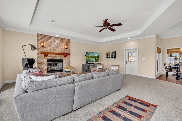 131 High Lonesome Dr, Alpine, TX 79830 - carpeted living area featuring a tray ceiling, a brick fireplace, a ceiling fan, baseboards, and recessed lighting