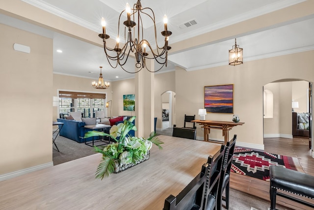 131 High Lonesome Dr, Alpine, TX 79830 - dining room with arched walkways, a chandelier, wood finished floors, ornamental molding, and baseboards