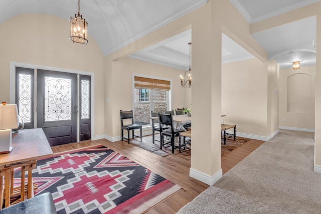 131 High Lonesome Dr, Alpine, TX 79830 - foyer entrance with a chandelier, wood finished floors, arched walkways, baseboards, and ornamental molding