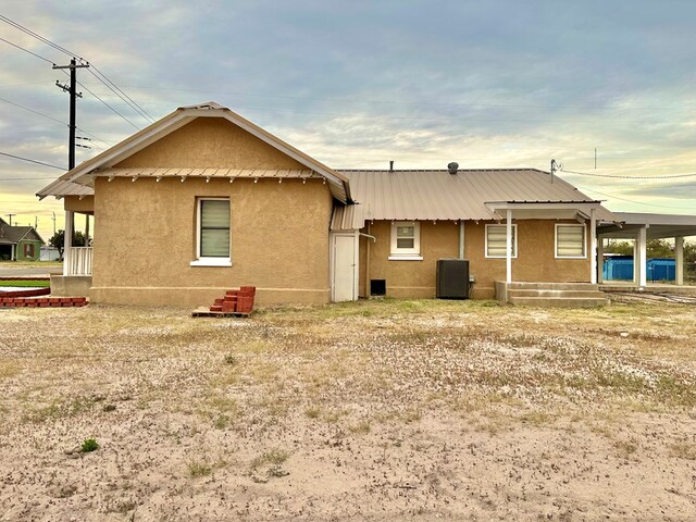 rear view of property featuring central air condition unit