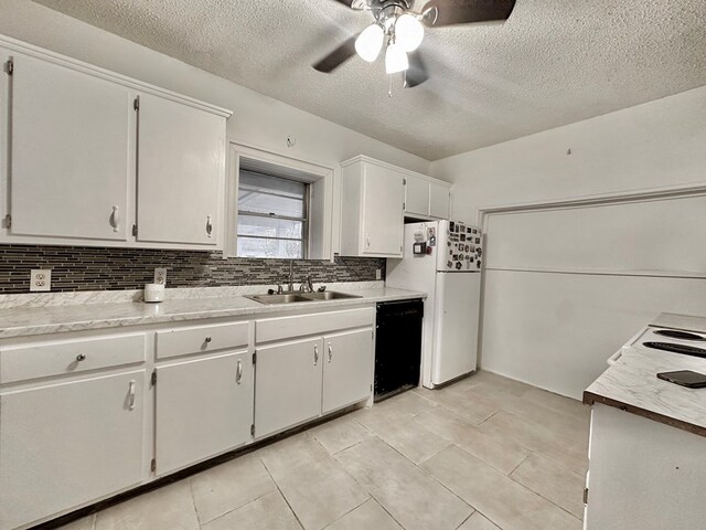 kitchen featuring white cabinets, white refrigerator, sink, decorative backsplash, and black dishwasher