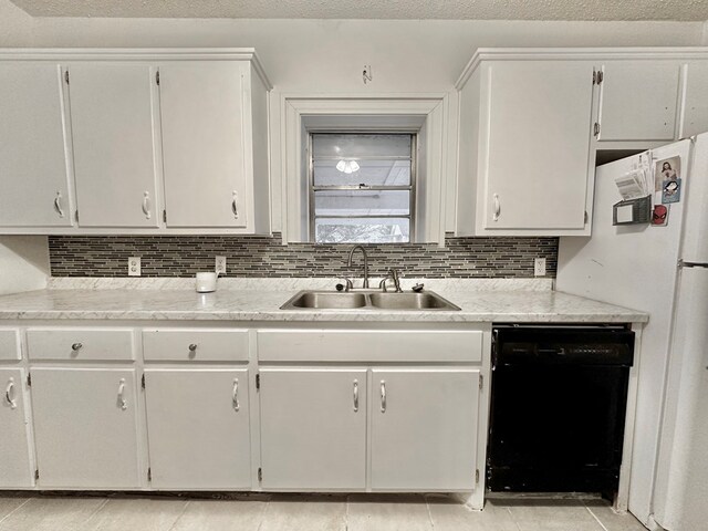 kitchen featuring backsplash, dishwasher, white cabinetry, and sink