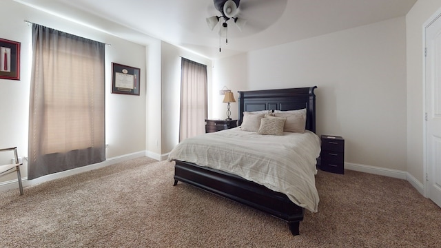 carpeted bedroom featuring ceiling fan and baseboards