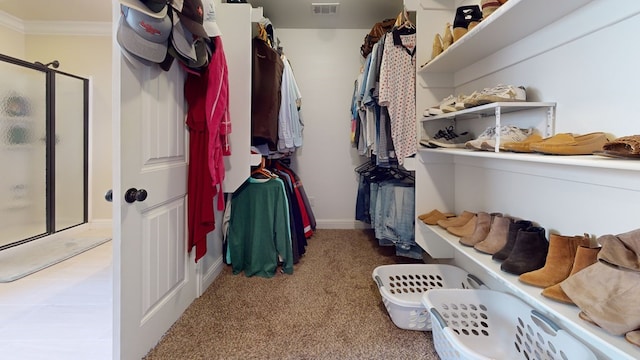 walk in closet with light carpet and visible vents