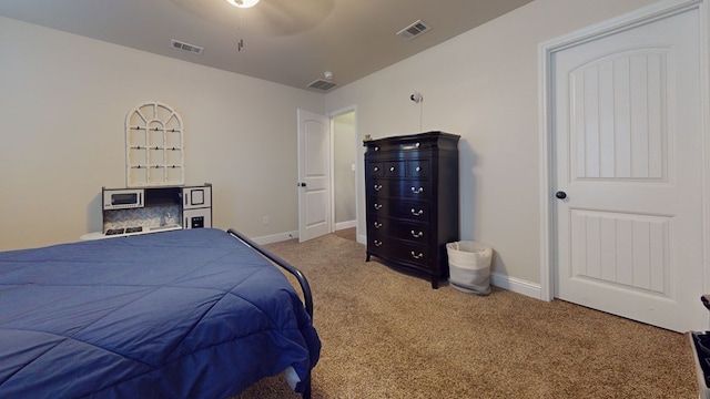 bedroom with carpet, visible vents, and baseboards