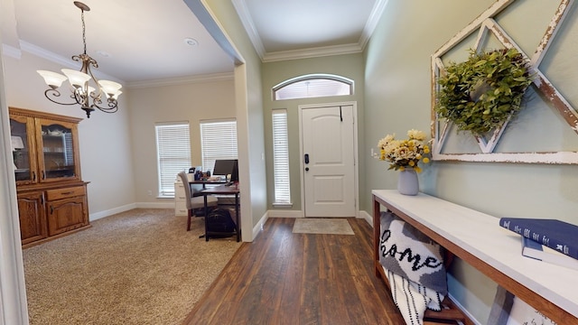 entryway featuring baseboards, ornamental molding, dark wood-type flooring, and a notable chandelier