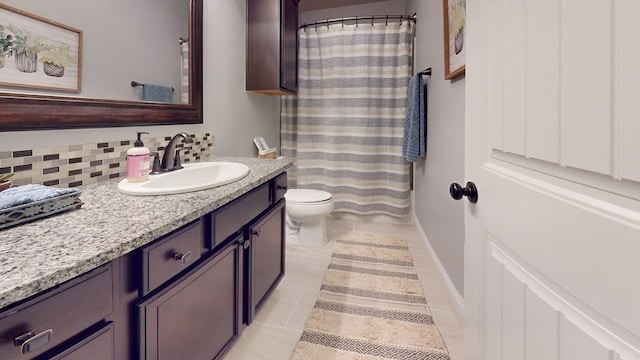 full bath with baseboards, decorative backsplash, toilet, tile patterned flooring, and vanity