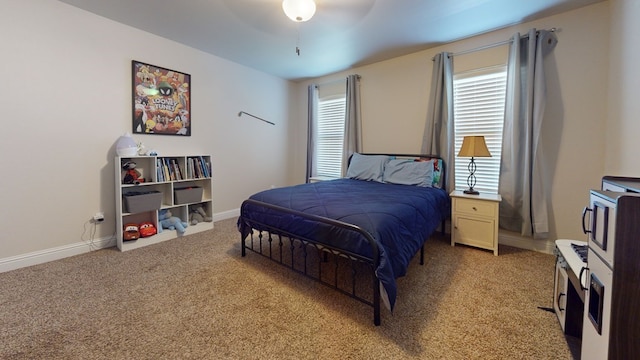 bedroom with light carpet and baseboards