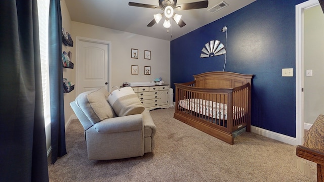 carpeted bedroom featuring ceiling fan, visible vents, and baseboards