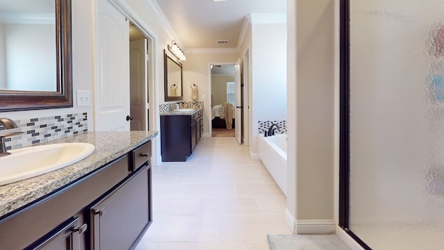 bathroom featuring ornamental molding, backsplash, two vanities, and a sink