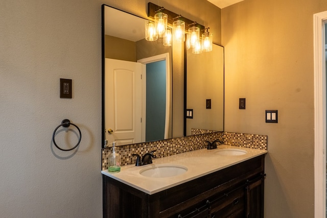 bathroom with a sink, decorative backsplash, and double vanity