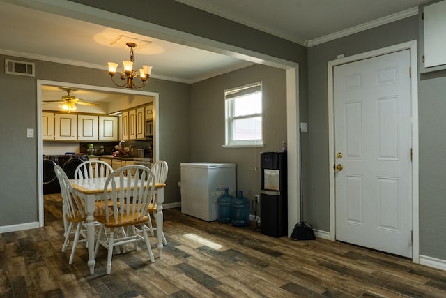 dining space featuring dark wood-style floors, baseboards, visible vents, and ornamental molding