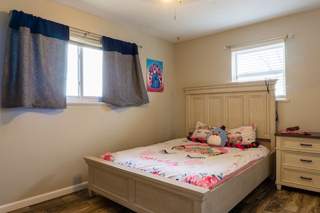 bedroom featuring baseboards and dark wood finished floors