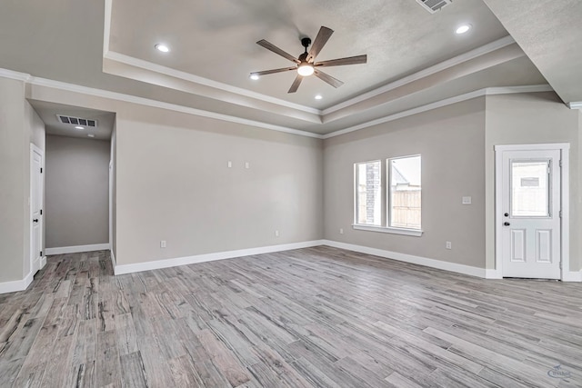 unfurnished living room with a raised ceiling, ceiling fan, and light hardwood / wood-style floors