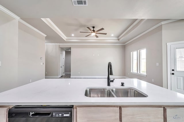 kitchen featuring dishwasher, a raised ceiling, crown molding, ceiling fan, and sink