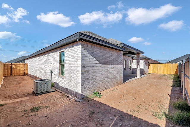 view of property exterior with a patio area and central AC