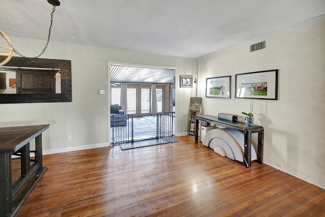 entryway with french doors, wood finished floors, visible vents, and baseboards