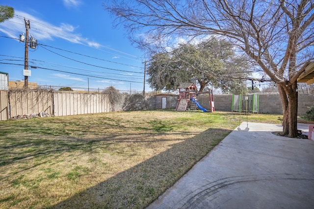 view of yard with a patio area, a playground, and a fenced backyard