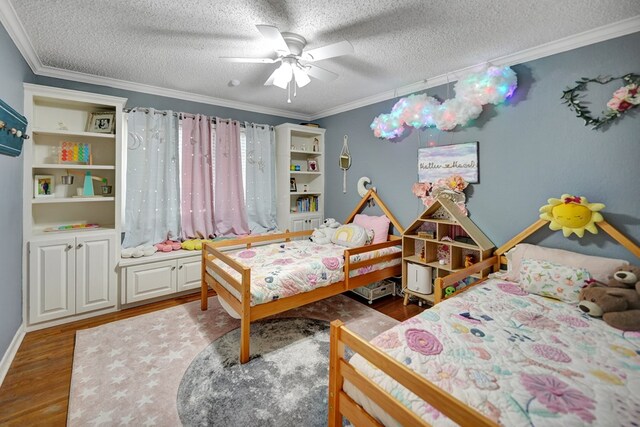 bedroom with a ceiling fan, crown molding, a textured ceiling, and wood finished floors