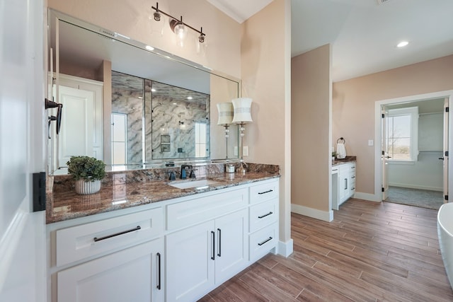 bathroom with wood-type flooring, vanity, and an enclosed shower