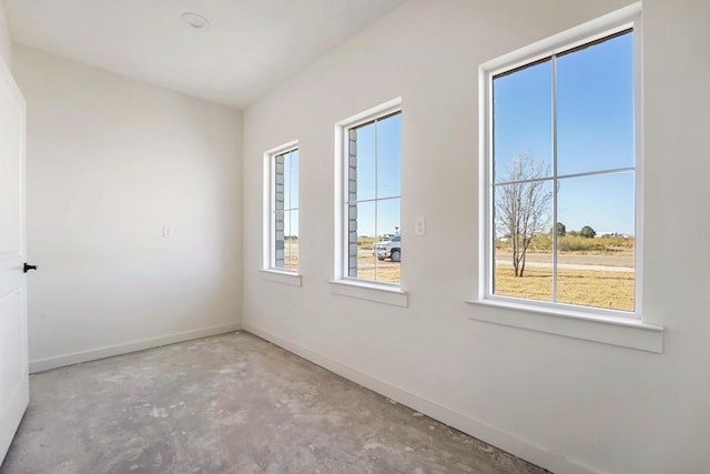 unfurnished room with concrete flooring