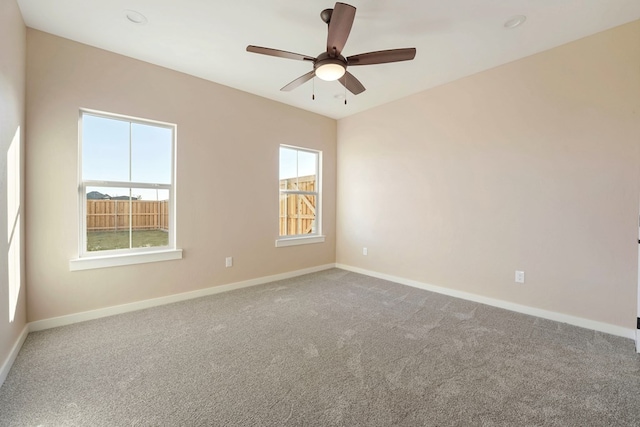 carpeted spare room with ceiling fan