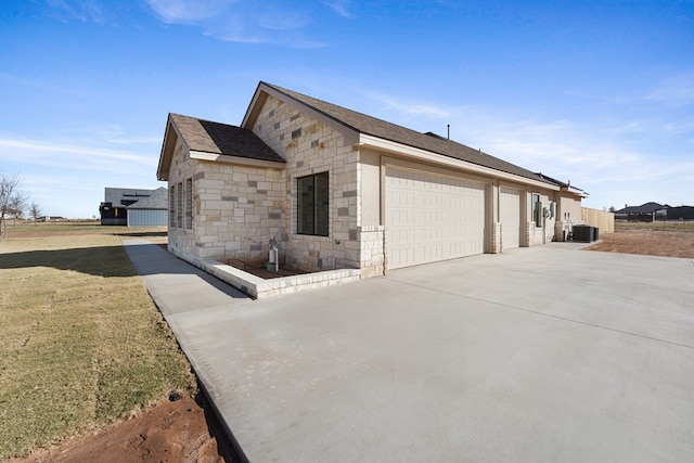 view of home's exterior featuring central AC and a garage